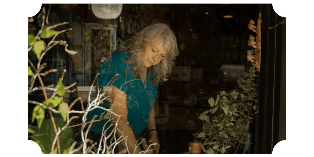 Sherri Stickler, founded of Synergy Herbal Works Herbal Apothecary in Tennessee tending to plants and products inside the shop. 